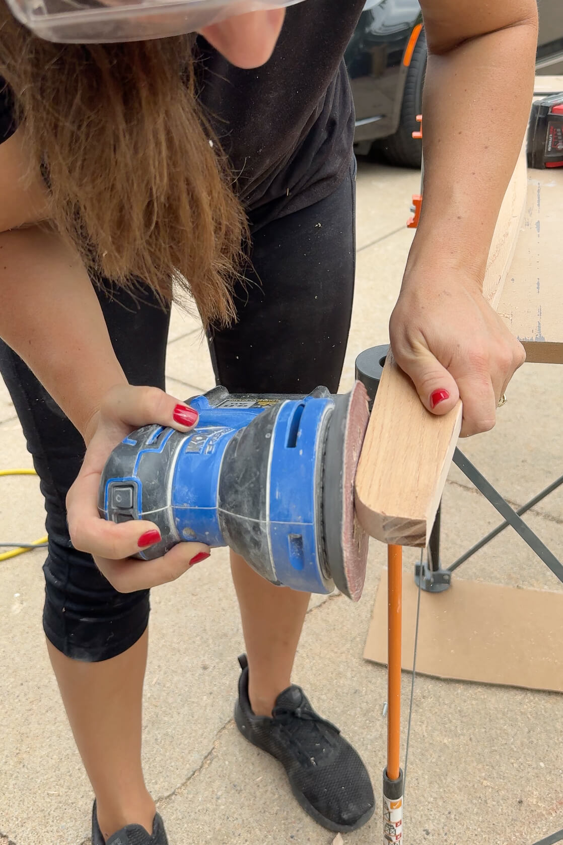 Cutting off a rounded corner on the top of a DIY bunk bed ladder.